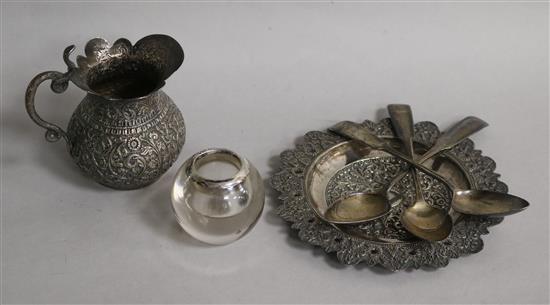 An Indian white metal jug and dish, a silver mounted glass match tidy and three Scottish silver teaspoons.
